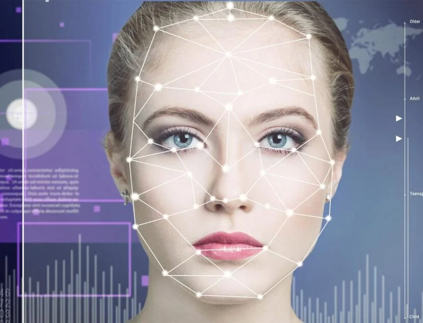 How AI Is Being Used to Track and Manage Eczema Symptoms A woman's face is overlaid with a digital grid and geometric lines, indicating facial recognition technology. Background includes graphs and abstract data visuals.